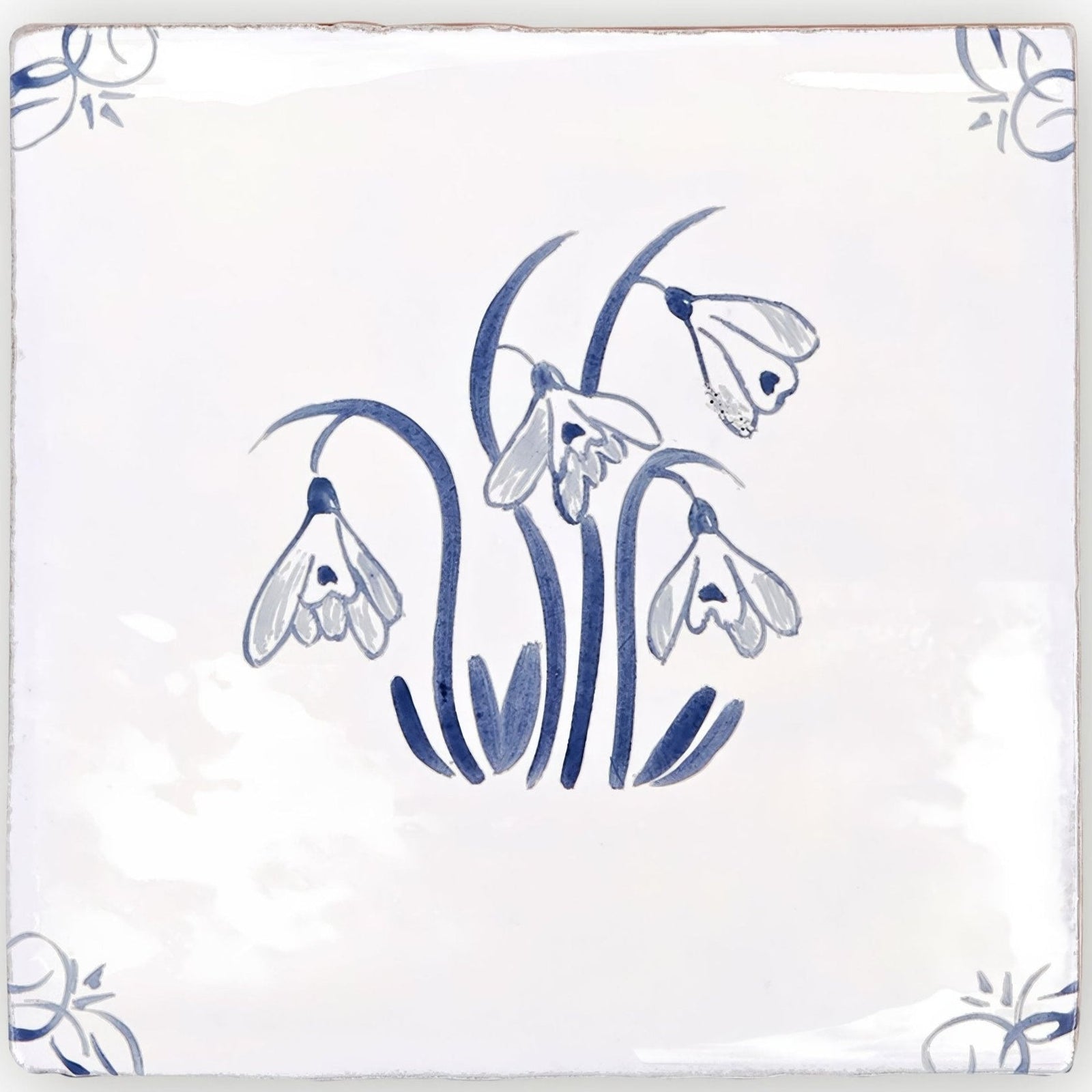 White ceramic english delft snowdrop blue gloss tile with delicate hand-painted blue snowdrop design