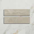 Two rectangular beige enki limestone parquet tiles with textured natural stone effect and velvet finish surface