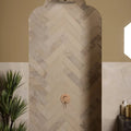 Beige herringbone patterned enki limestone parquet stone tiles with velvet finish and subtle natural veining