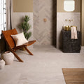 Gold basin sink with black marble pedestal featuring enki limestone velvet finish for elegant bathroom decor
