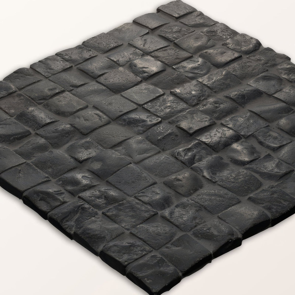 Enso cobble mosaic cube charcoal black textured stone tile with rustic uneven surface and interlocking square pieces