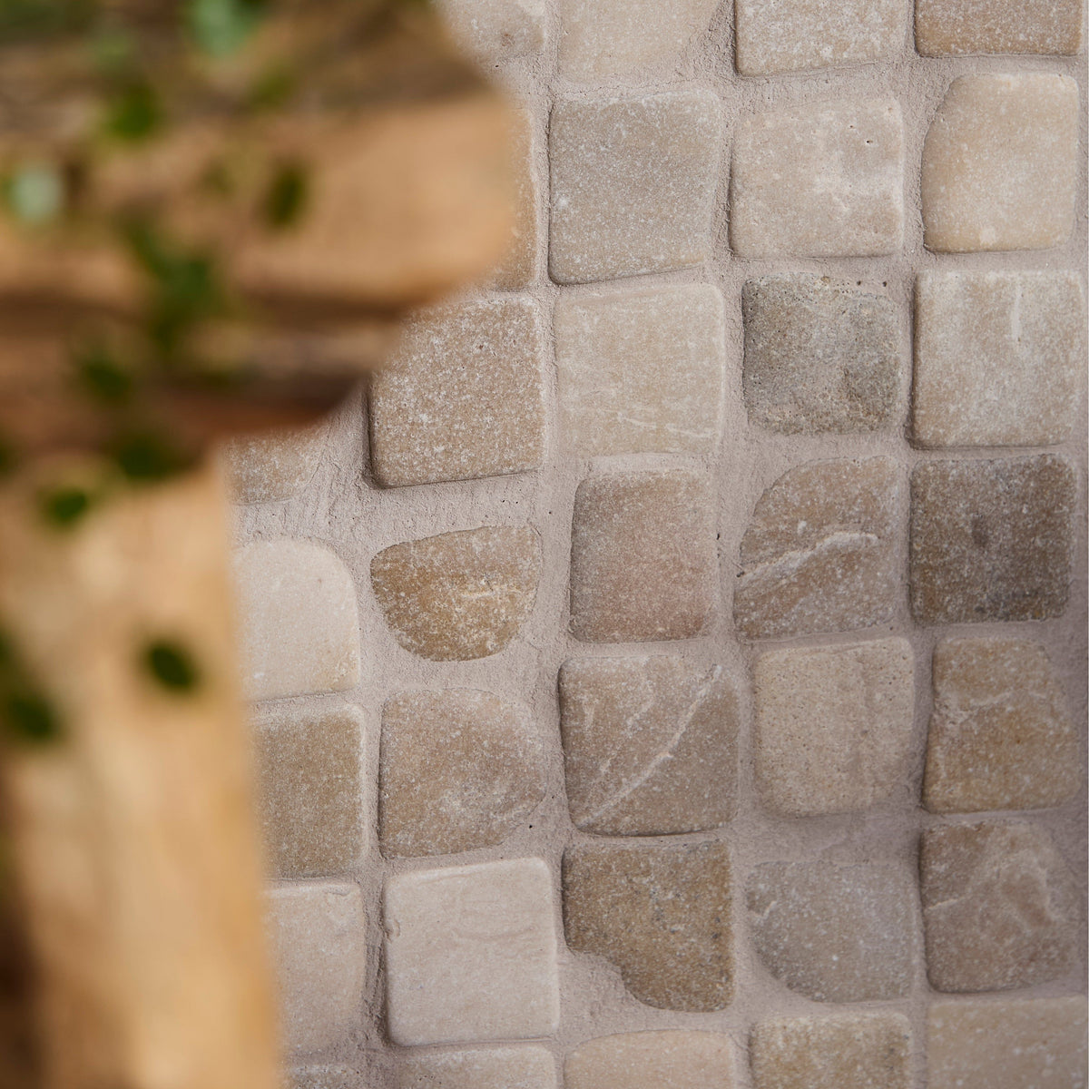 Beige and gray stone mosaic tile with irregular naturally textured pieces in enso cobble mosaic cube sand design