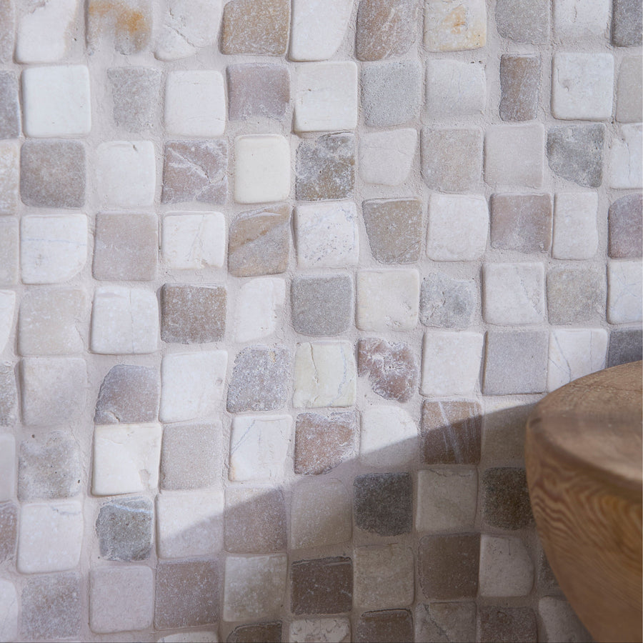 Beige and white natural stone mosaic tile wall in Enso Cobble Mosaic Cube Sand and Chalk Chess design