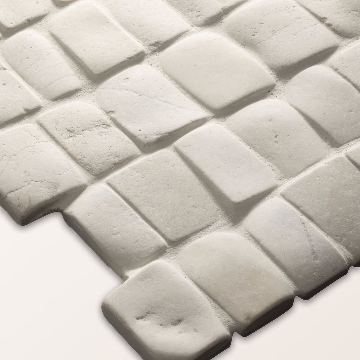 Enso Cobble Mosaic Strip Chalk white textured stone mosaic tile with subtle gray tone and irregular rectangular shapes