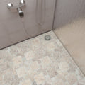 Room setting with tumbled travertine Casablanca mosaic covering a bathroom wall