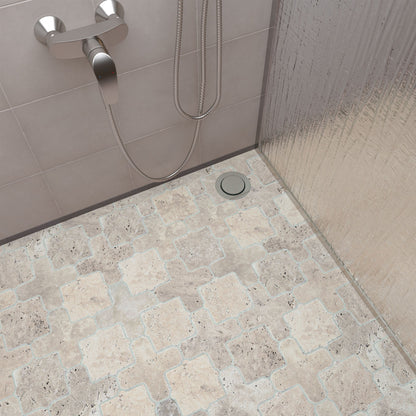 Room setting with tumbled travertine Casablanca mosaic covering a bathroom wall