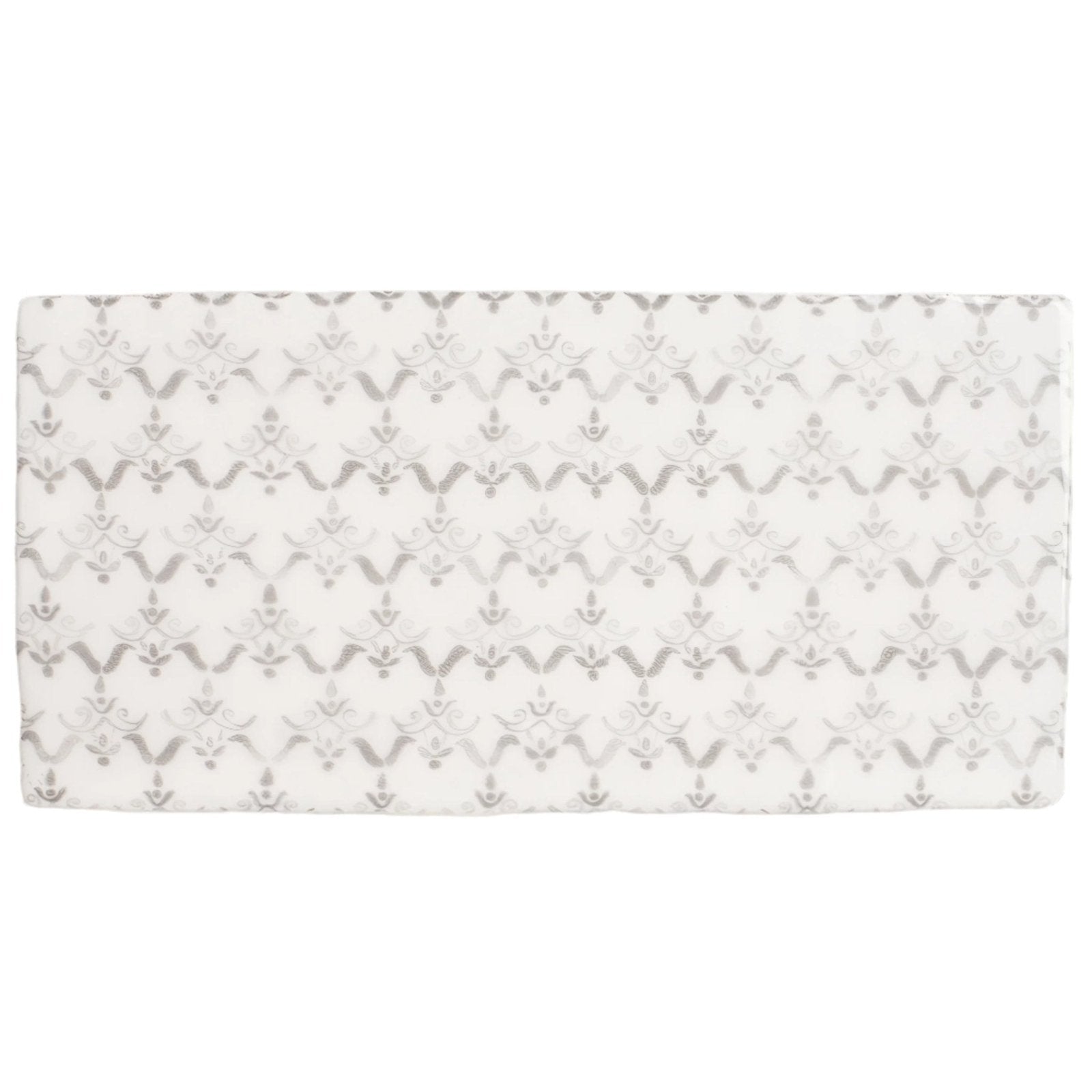 A rectangular white crib sheet with a silver-toned damask pattern from fabrique clara dove grey collection