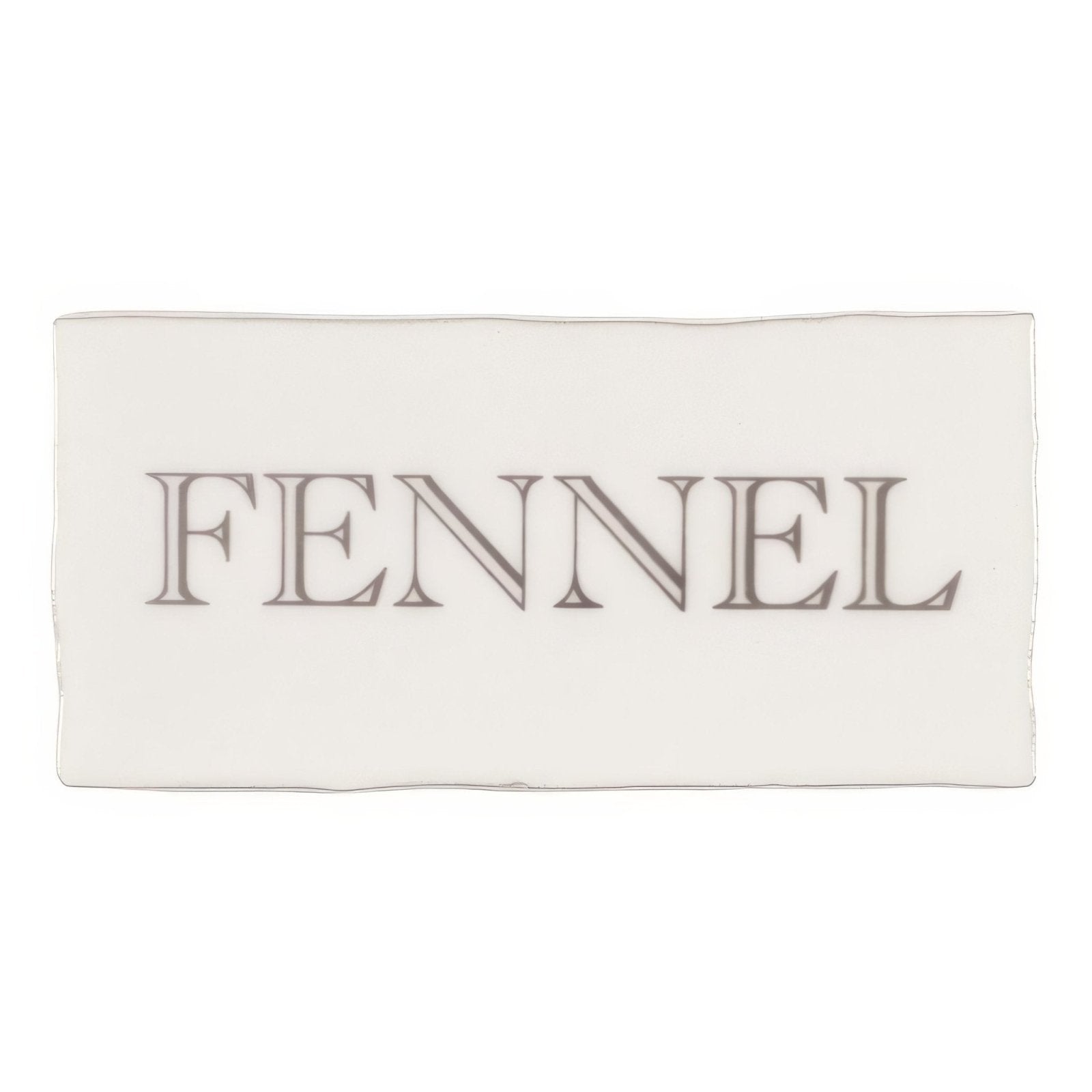 A rectangular white ceramic plate with the word fennel in gray serif font from fennel in grey on cotton