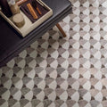 Figure shell dark mosaic gray and white marble effect tiles arranged in a repeating scallop pattern