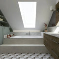 Figure Shell Dark Mosaic grey and white marble scallop mosaic behind a white bathtub