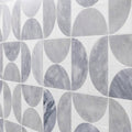 Gray marble tiles with circular geometric pattern set in white grout figure spiral light mosaic design
