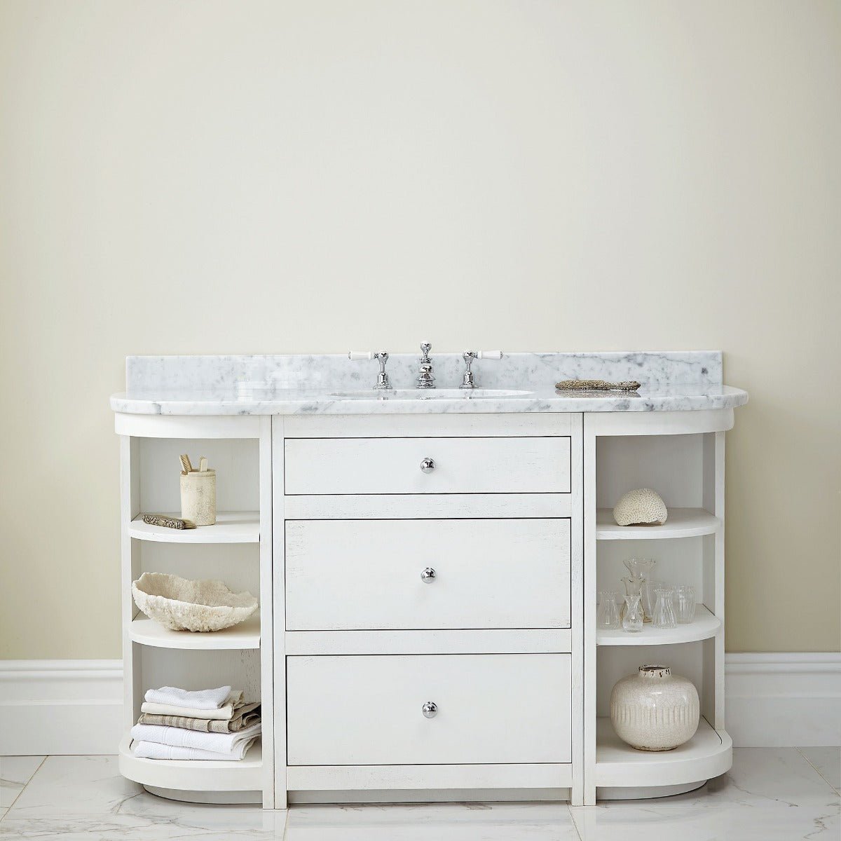 Flake white bathroom vanity with white marble top three drawers and open shelving on either side