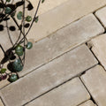Beige rectangular flanders buff tumbled clay pavers with textured slightly weathered stone surface