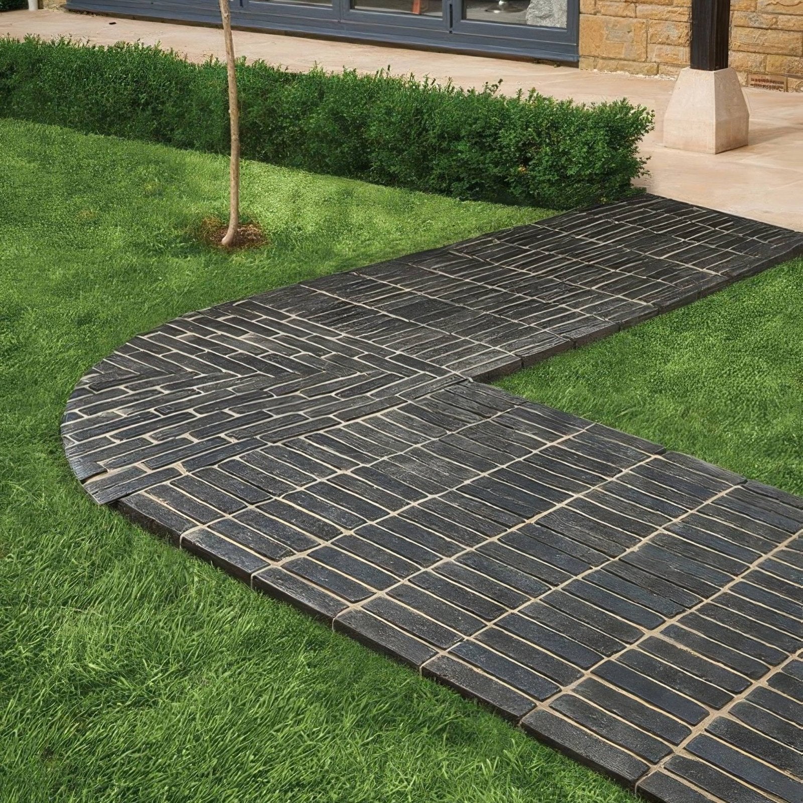 Flanders charcoal tumbled clay pavers in black brick style forming a curved pathway through grass