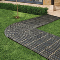 Flanders charcoal tumbled clay pavers in black brick style forming a curved pathway through grass