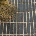 Flanders charcoal tumbled clay pavers in dark gray rectangular bricks with light beige mortar in running bond pattern