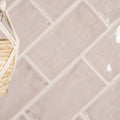 Beige rectangular glass flint brick tiles arranged in a herringbone pattern for wall or backsplash use