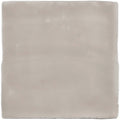 A square matte-finished ceramic tile in soft gray with subtle variations and uneven edges called flint field tile