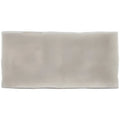 A sleek rectangular flint half tile wall tile with a smooth matte finish in subtle grayish white ceramic