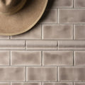 Beige rectangular ceramic flint half tile wall tiles with subtle matte finish arranged in a classic brick pattern
