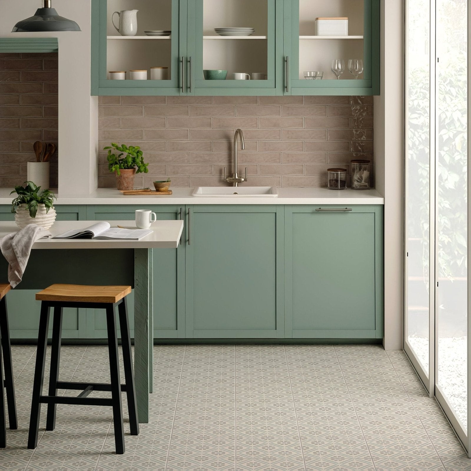 Mint green shaker-style kitchen cabinets with glass-front upper doors and silver handles with flint large brick tile