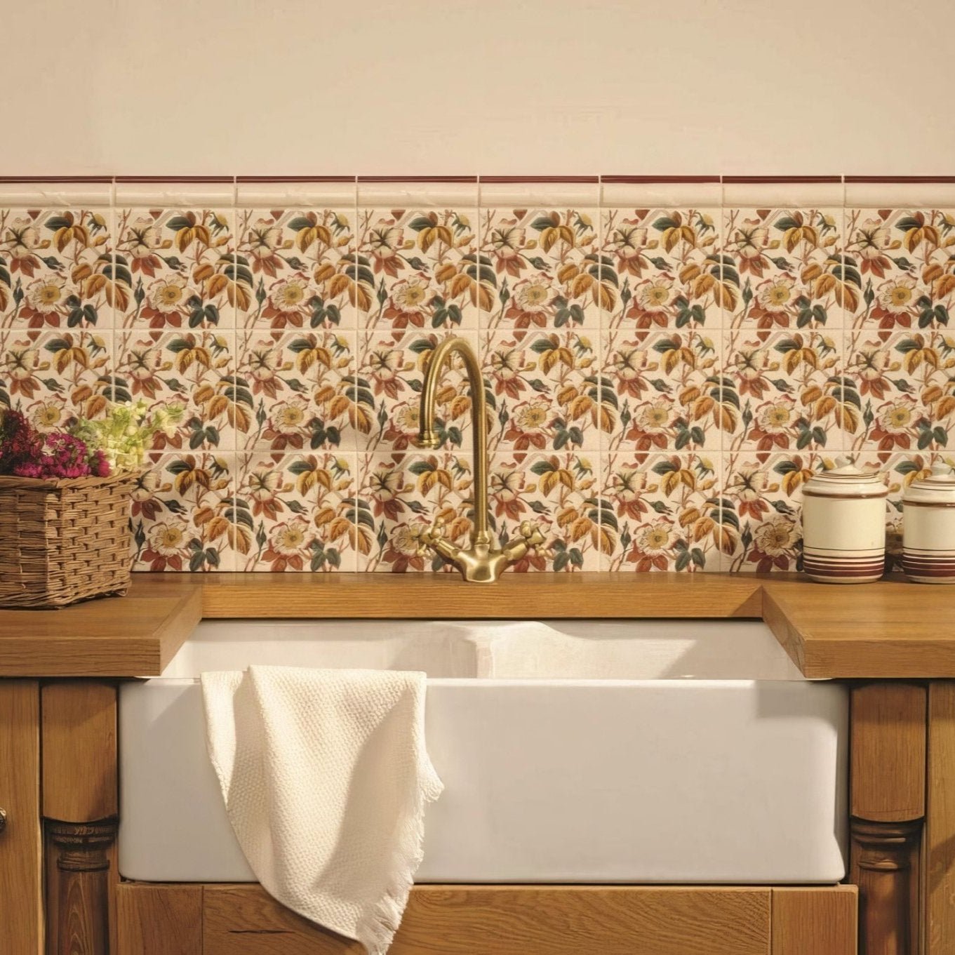 White ceramic farmhouse sink with gold-toned faucet and wooden countertop in floral trellis continuous pattern on county white