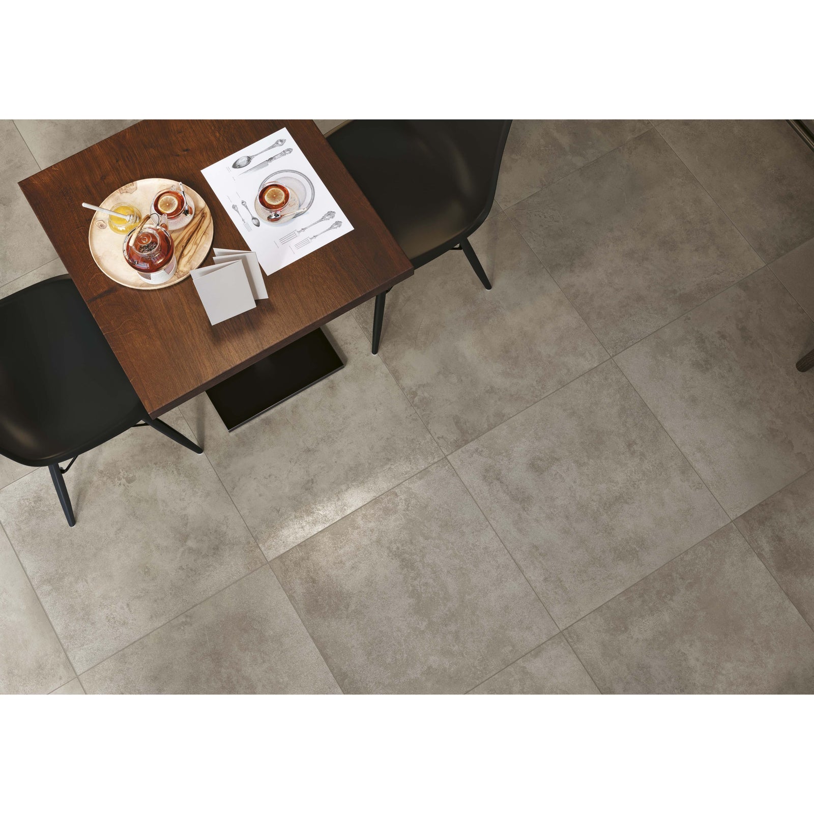 Flux Concrete Matt 60 x 60cm grey concrete-effect tiles with a dark wood table