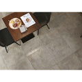 Flux Concrete Matt 60 x 60cm grey concrete-effect tiles with a dark wood table