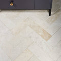 Beige marble honed finish folio tiles arranged in a herringbone pattern measuring 10 x 30.5cm