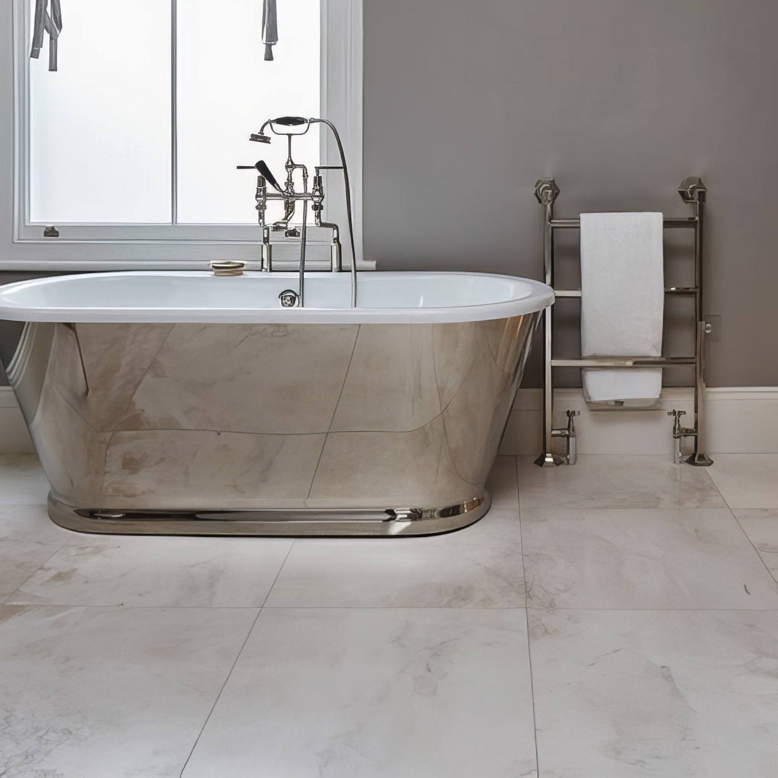 Shiny chrome freestanding bathtub with white interior and classic faucet fixtures in folio marble honed finish 61 x 61cm