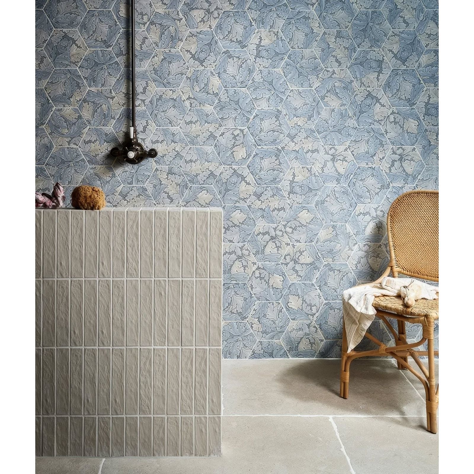 Woven rattan chair with light beige fabric draped over the seat from the folly porcelain lake matt collection
