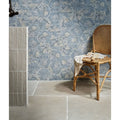Woven rattan chair with light beige cloth draped over seat in folly porcelain lake matt finish
