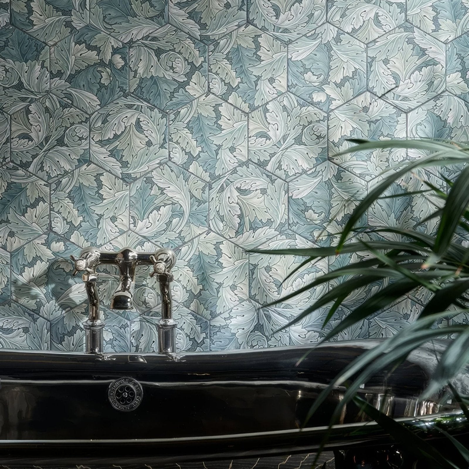 Hexagonal blue and white porcelain tiles with intricate leaf patterns in moss matt finish as decorative wall backdrop