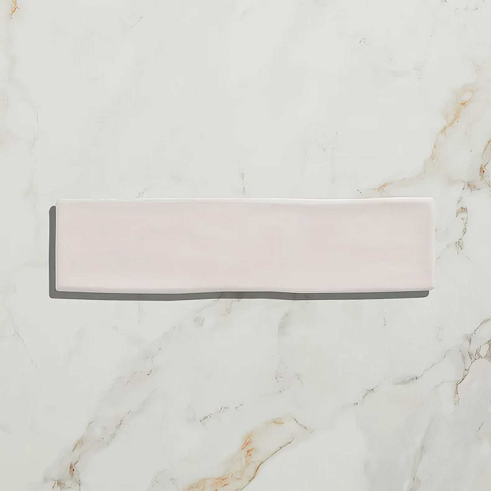 A soft blush pink fondant ceramic ecru tile with a smooth glossy rectangular ceramic finish