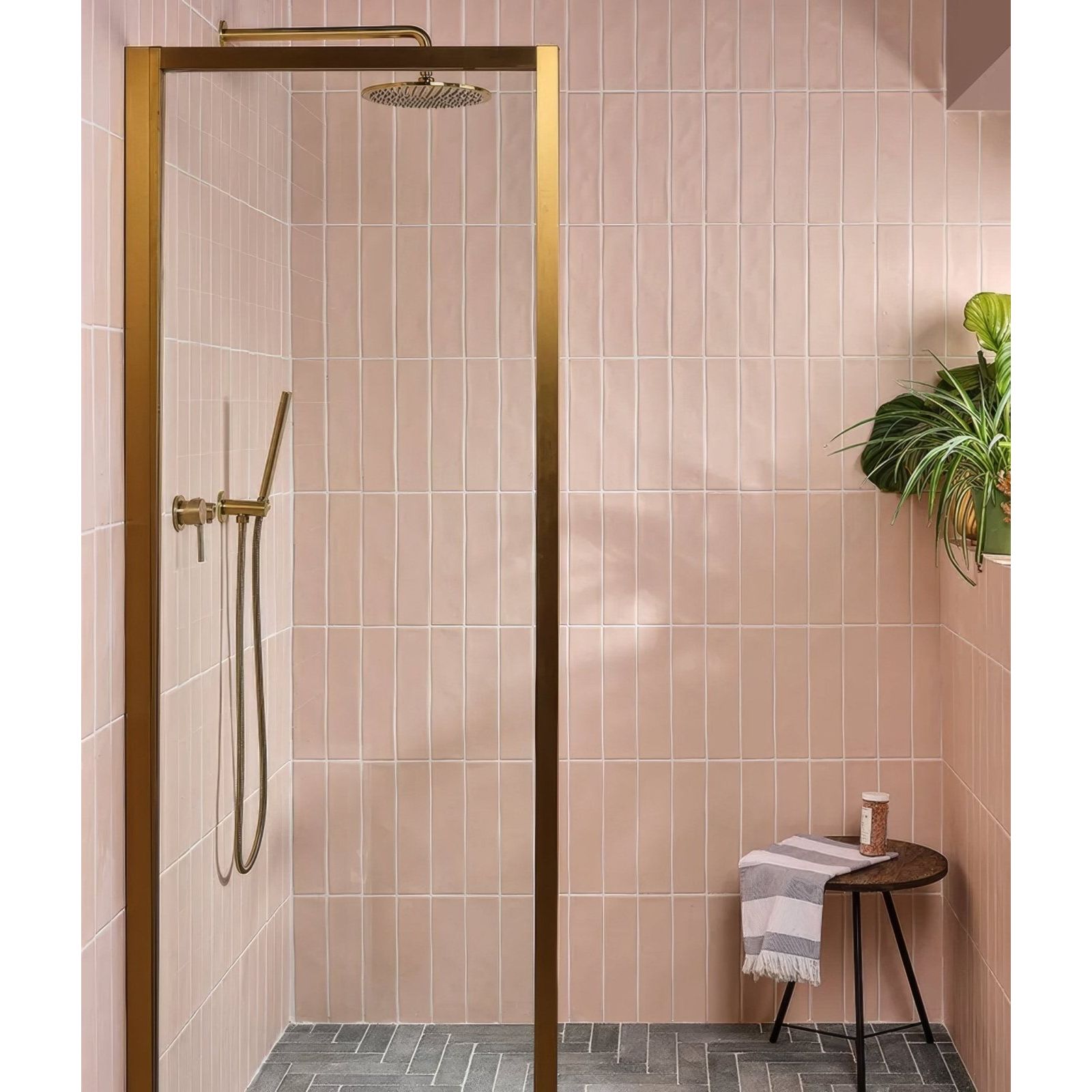 Fondant ceramic rose gold framed shower enclosure with matching gold rainhead and handheld shower wand
