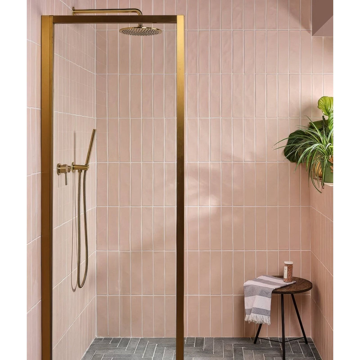 Fondant ceramic rose gold framed shower enclosure with matching gold rainhead and handheld shower wand