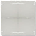Four square, glossy gray ceramic tiles arranged in a grid.