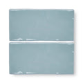 Two forecast forth rectangle glazed tiles with matte light blue ceramic finish and white speckles on edges