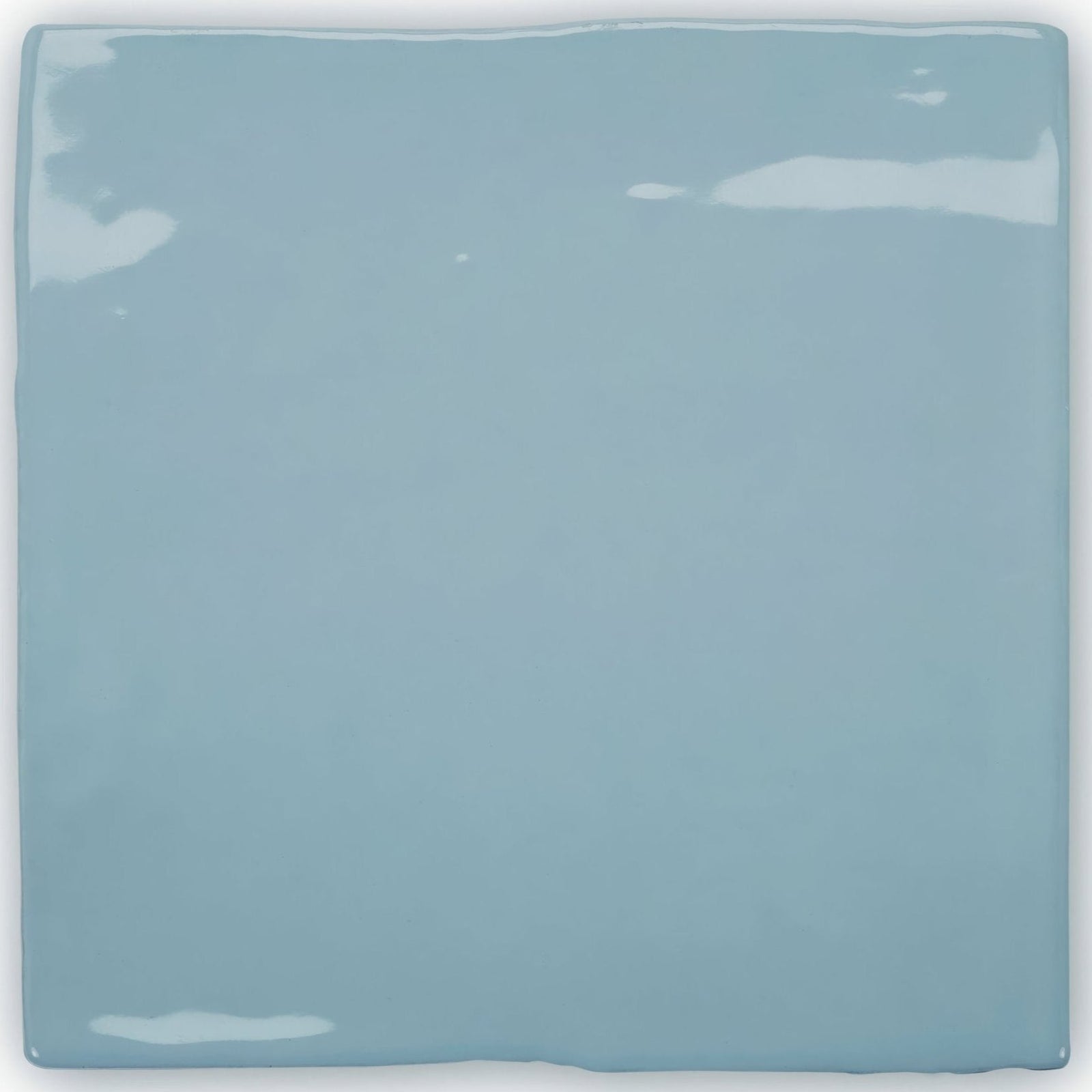 A square glossy light blue ceramic tile with slightly uneven edges from forecast forth square glazed tile collection