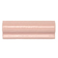 A glossy blush pink ceramic crown molding piece with a smooth curved profile from Forecast Lundy Glazed Dado