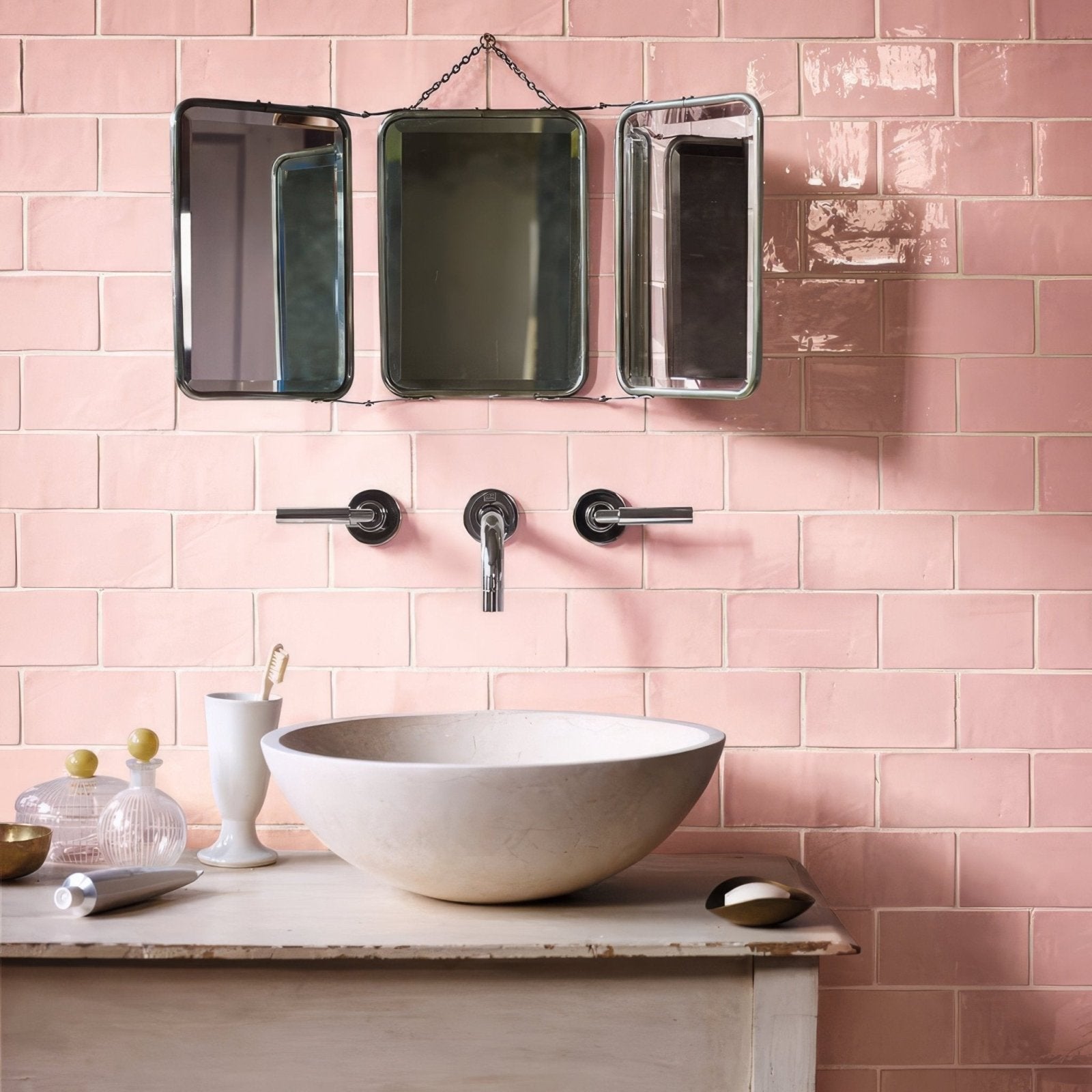 A white ceramic bowl sink with a smooth rounded surface on a rustic countertop featuring forecast lundy rectangle glazed tile