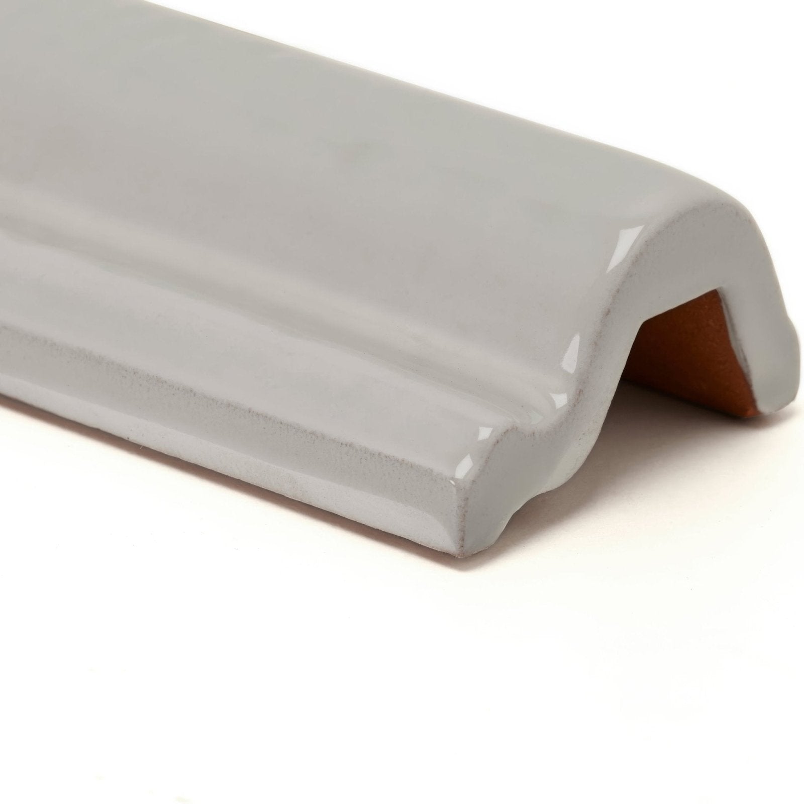 Gray ceramic corner trim with a glossy finish and subtle ridged texture from forecast portland glazed dado