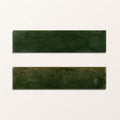 Two rectangular green porcelain alligator green tiles with matte textured surface and subtle shade variations