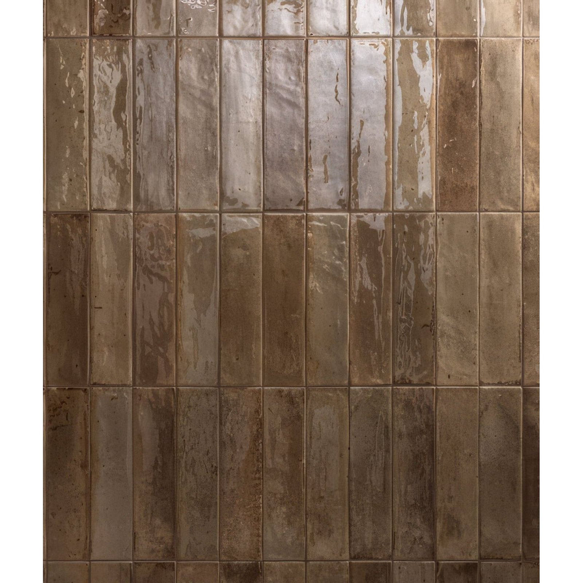 Rectangular glossy brown porcelain tiles with a rustic glazed finish arranged in vertical rows for flooring or walls