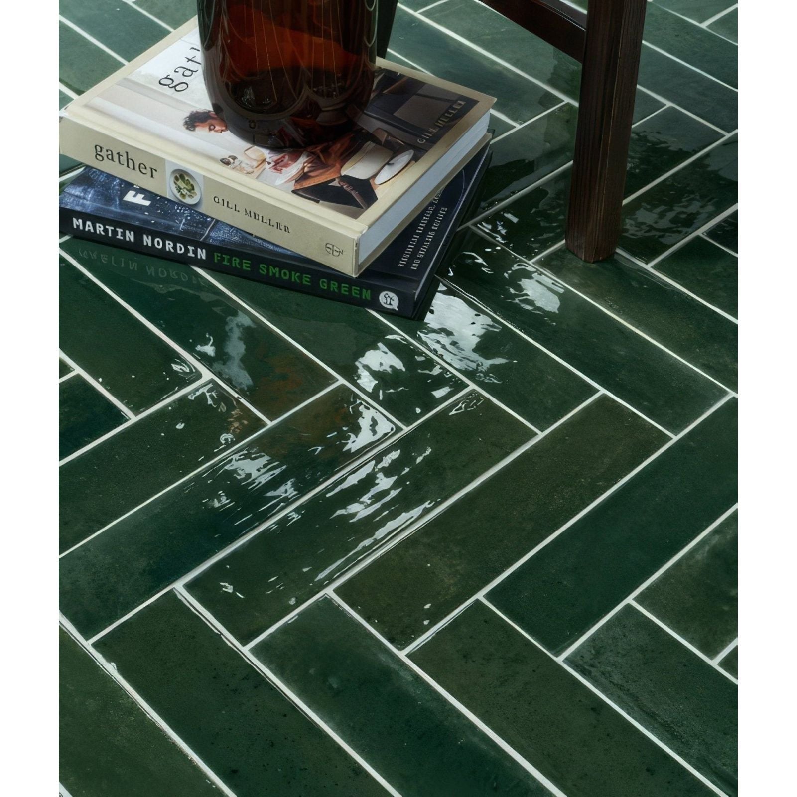 Foundry novo porcelain irish green dark green glossy rectangular tiles arranged in a herringbone pattern with white grout