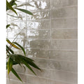 Shiny translucent gray rectangular porcelain tiles with subtle texture foundry novo linen finish
