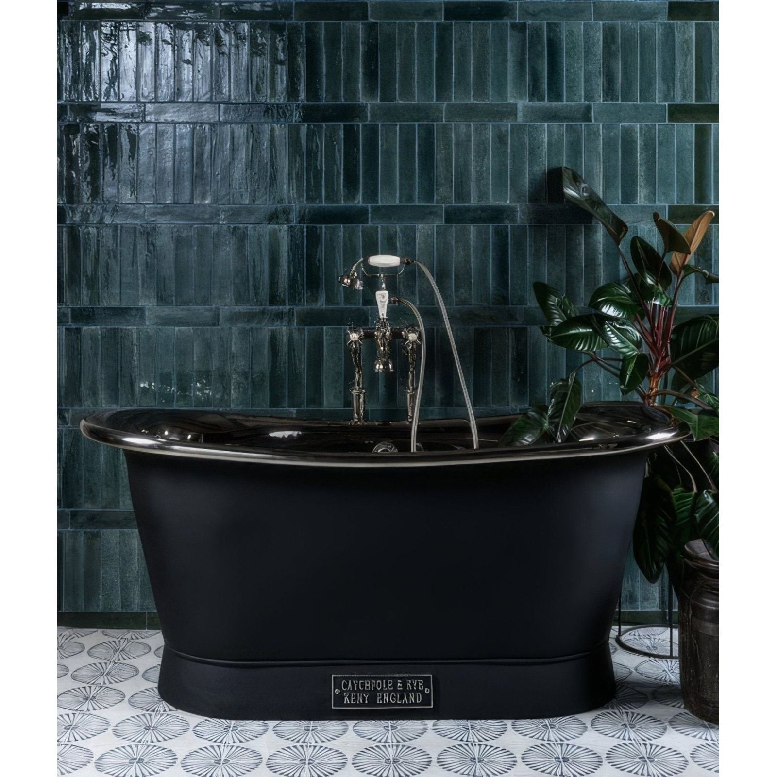Black matte freestanding porcelain bathtub with polished chrome faucet against dark green textured tiles foundry novo navy