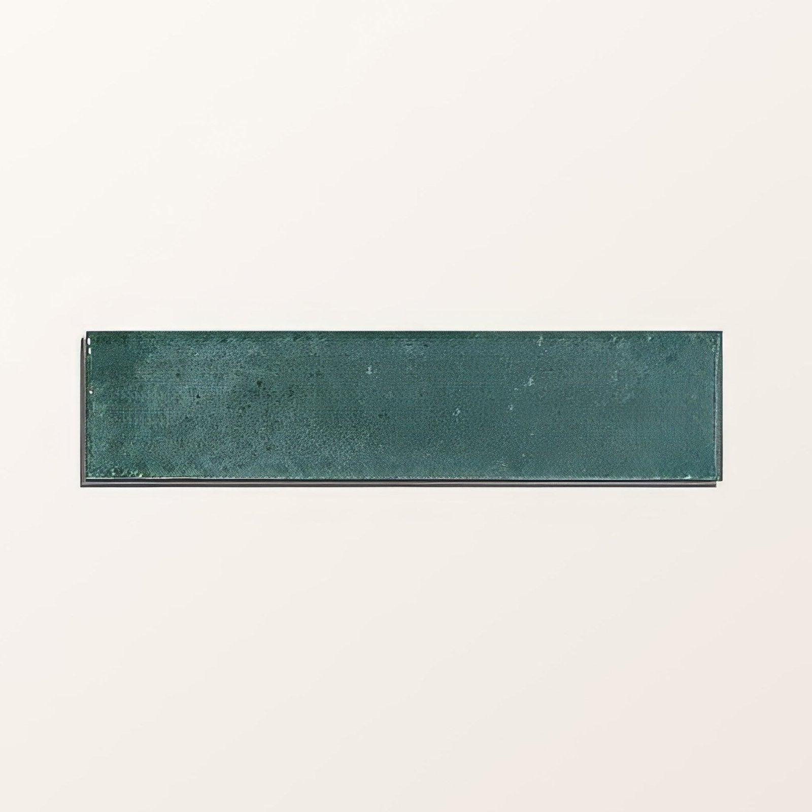 Rectangular teal green ceramic tile with textured slightly distressed surface from foundry novo porcelain turquoise collection