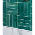 Foundry novo porcelain turquoise emerald green rectangular tiles with matte textured finish in herringbone pattern