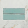 Two teal matte rectangular ceramic tiles with subtle texture from foundry porcelain aquamarine collection